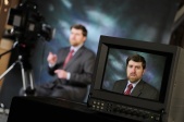 Monitor in production on location showing spokesperson for ADA talking to teleprompter on video camera